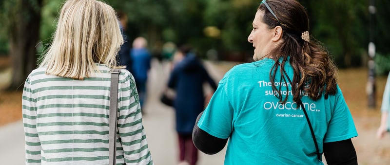 Two women walking wearing an Ovacome t-shirt