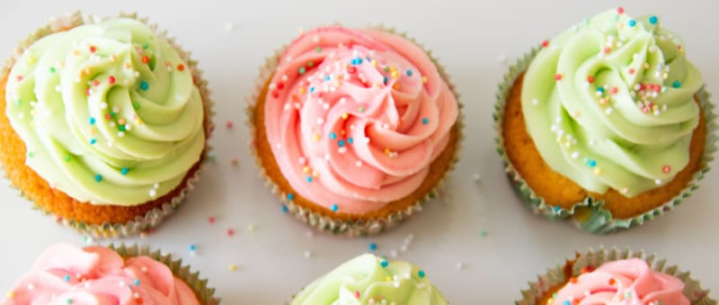 Three cupcakes with pink and green icing