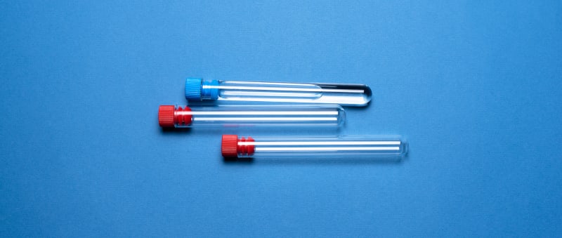 Empty test tubes on a blue background