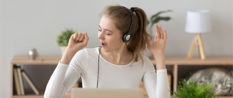 Photo of person listening to music and singing